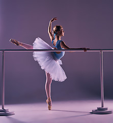 Image showing classic ballerina posing at ballet barre