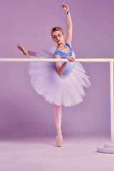 Image showing classic ballerina posing at ballet barre