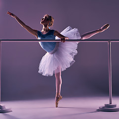 Image showing classic ballerina posing at ballet barre