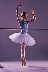 Image showing classic ballerina posing at ballet barre