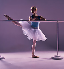 Image showing classic ballerina posing at ballet barre