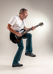 Image showing Full length portrait of a guitar player 