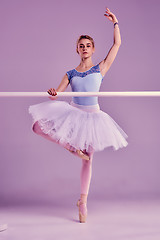 Image showing classic ballerina posing at ballet barre