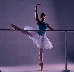 Image showing classic ballerina posing at ballet barre