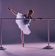 Image showing classic ballerina posing at ballet barre