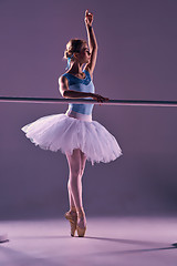 Image showing classic ballerina posing at ballet barre