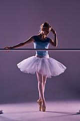 Image showing classic ballerina posing at ballet barre