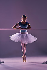 Image showing classic ballerina posing at ballet barre
