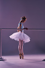 Image showing classic ballerina posing at ballet barre