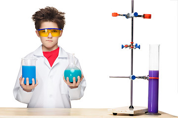 Image showing Little boy as chemist doing experiment with chemical fluid in the laboratory