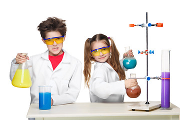 Image showing Two cute children at chemistry lesson making experiments