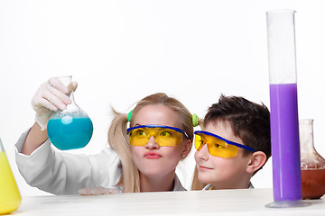 Image showing Teen and teacher of chemistry at  lesson making experiments