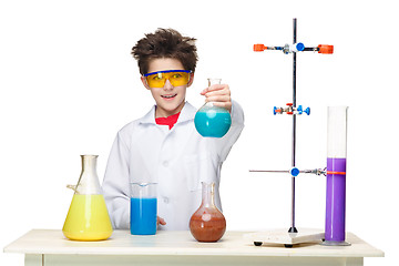 Image showing Little boy as chemist doing experiment with chemical fluid in the laboratory