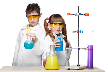 Image showing Two cute children at chemistry lesson making experiments