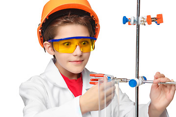 Image showing Little boy as chemist doing experiment with chemical fluid in the laboratory