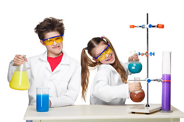 Image showing Two cute children at chemistry lesson making experiments