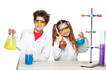 Image showing Two cute children at chemistry lesson making experiments