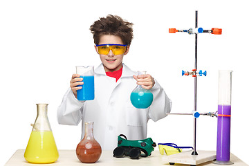 Image showing Little boy as chemist doing experiment with chemical fluid in the laboratory