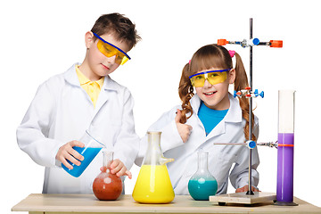 Image showing Two cute children at chemistry lesson making experiments