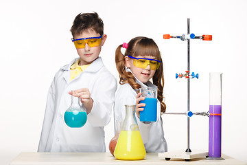 Image showing Two cute children at chemistry lesson making experiments