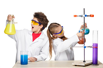 Image showing Two cute children at chemistry lesson making experiments