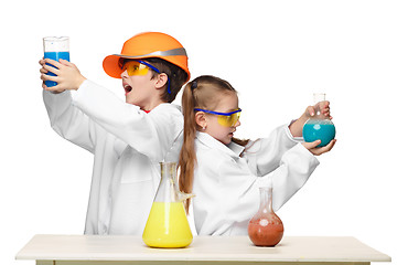 Image showing Two cute children at chemistry lesson making experiments