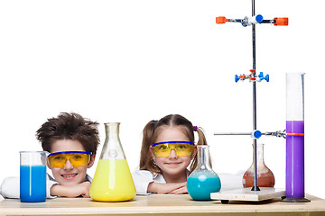 Image showing Two cute children at chemistry lesson making experiments