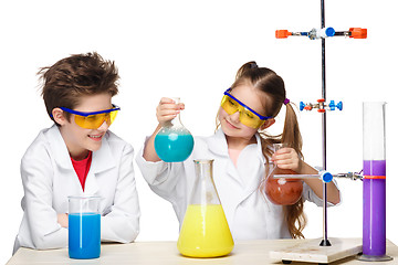 Image showing Two cute children at chemistry lesson making experiments