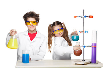 Image showing Two cute children at chemistry lesson making experiments