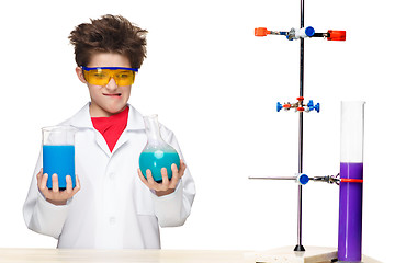 Image showing Little boy as chemist doing experiment with chemical fluid in the laboratory