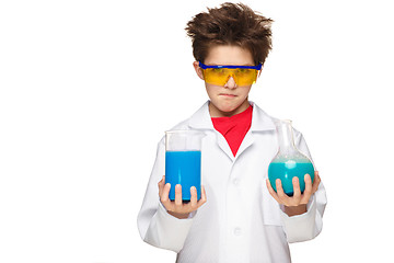 Image showing Little boy as chemist doing experiment with chemical fluid in the laboratory