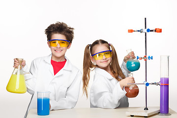 Image showing Two cute children at chemistry lesson making experiments