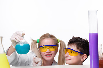 Image showing Teen and teacher of chemistry at  lesson making experiments