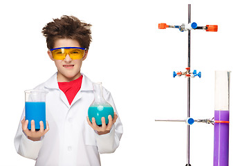 Image showing Little boy as chemist doing experiment with chemical fluid in the laboratory