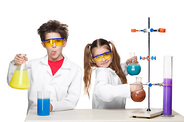 Image showing Two cute children at chemistry lesson making experiments