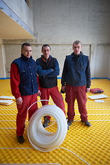 Image showing workers installing underfloor heating system