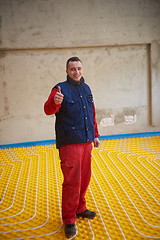 Image showing workers installing underfloor heating system