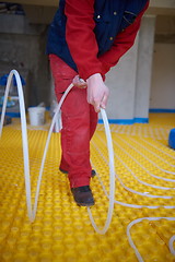 Image showing workers installing underfloor heating system