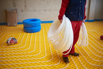 Image showing workers installing underfloor heating system