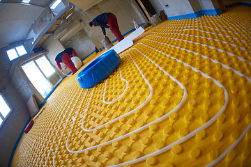 Image showing workers installing underfloor heating system