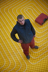 Image showing workers installing underfloor heating system