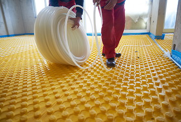 Image showing workers installing underfloor heating system