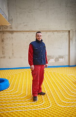 Image showing workers installing underfloor heating system