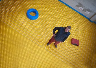 Image showing workers installing underfloor heating system