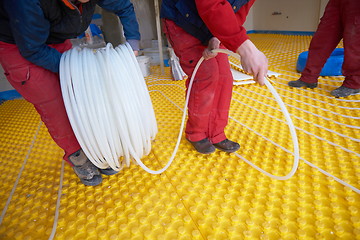 Image showing workers installing underfloor heating system