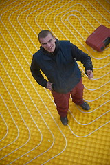 Image showing workers installing underfloor heating system