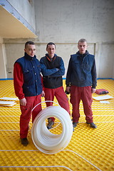 Image showing workers installing underfloor heating system