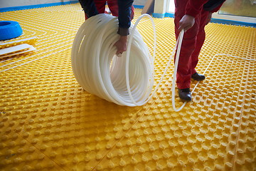 Image showing workers installing underfloor heating system