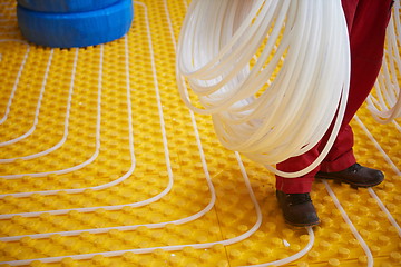 Image showing workers installing underfloor heating system