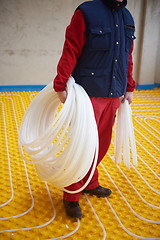 Image showing workers installing underfloor heating system